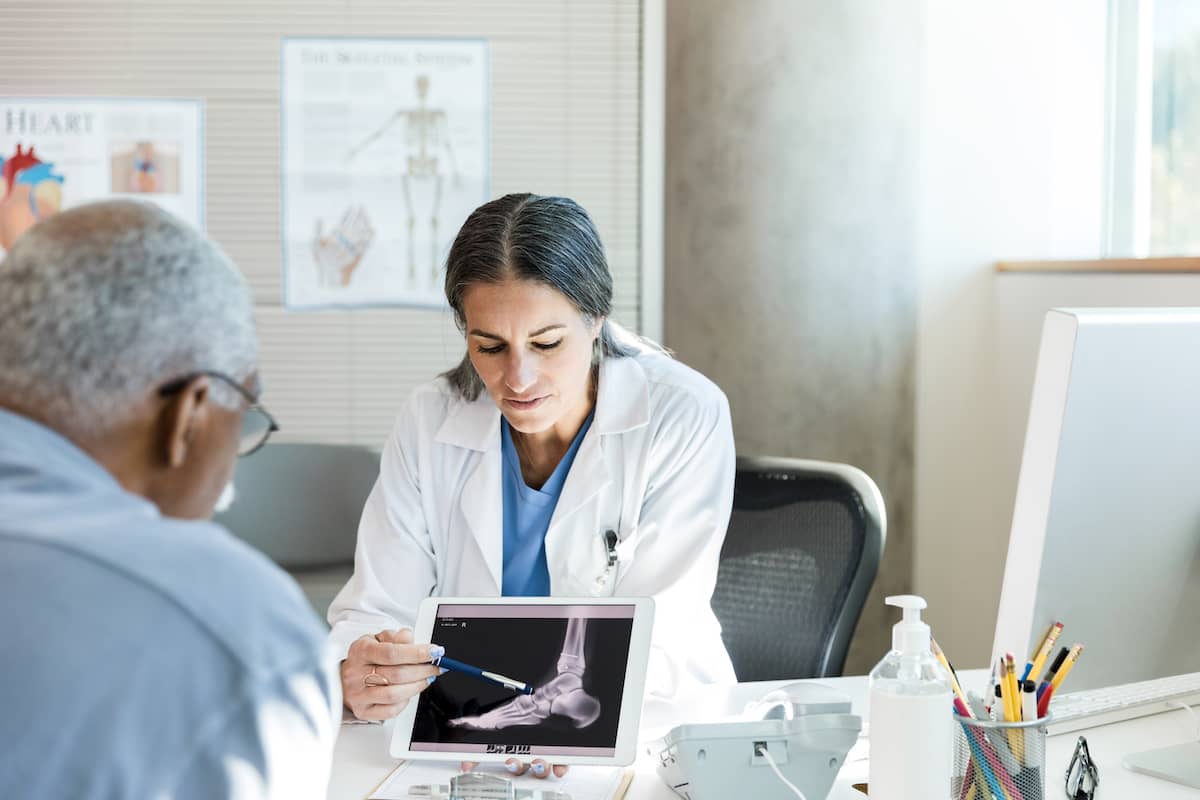 Doctor looks at foot x-ray