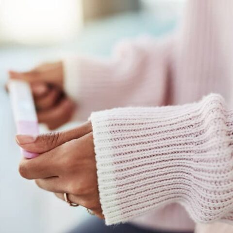 A person holds a pregnancy test